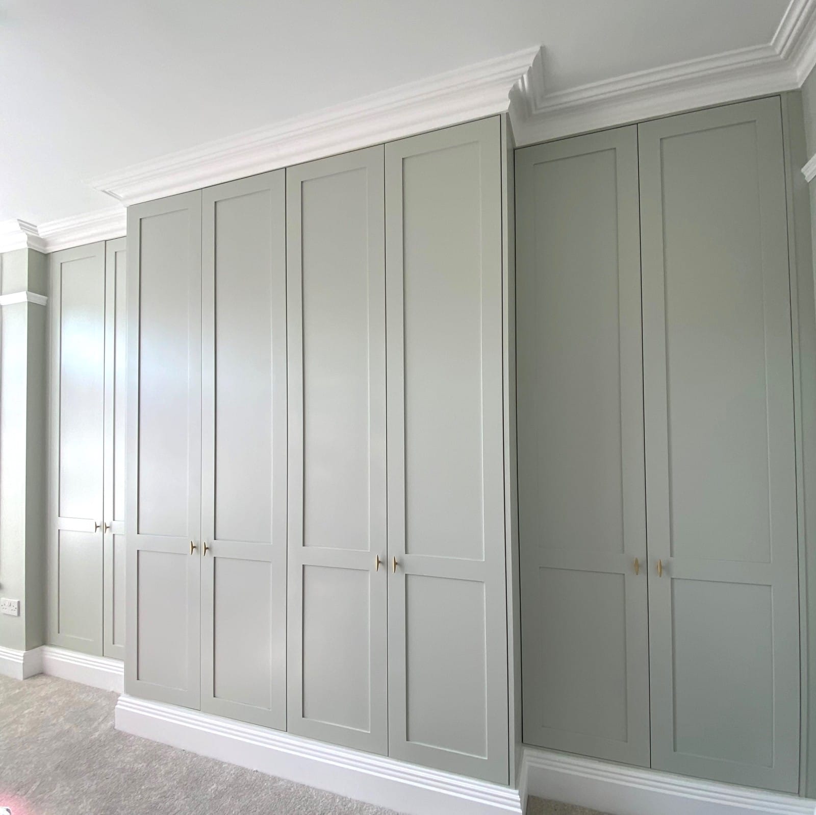 Wall-to-wall shaker style break front wardrobes